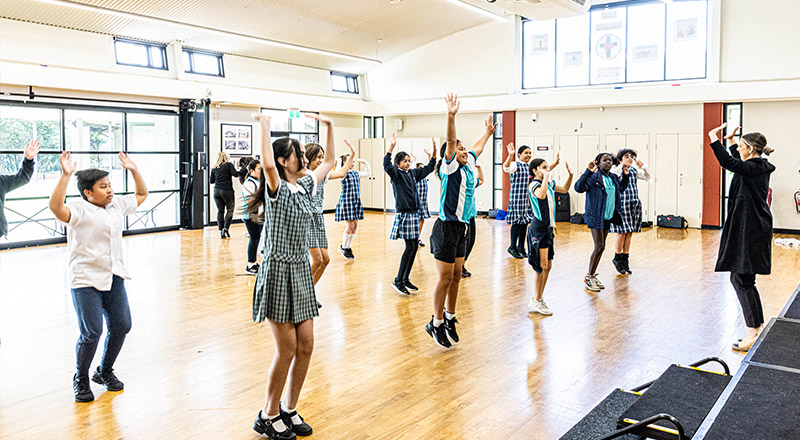 Students dancing in Holy Family Catholic Primary School Emerton hall