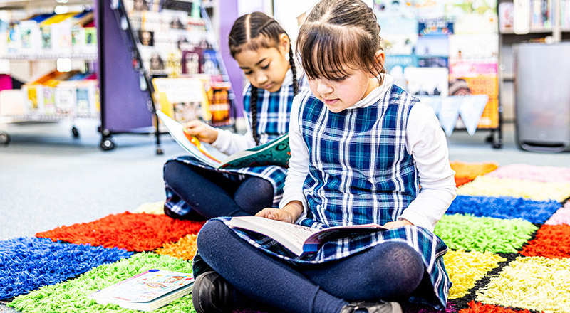 Two students in Holy Family Catholic Primary Emerton school library