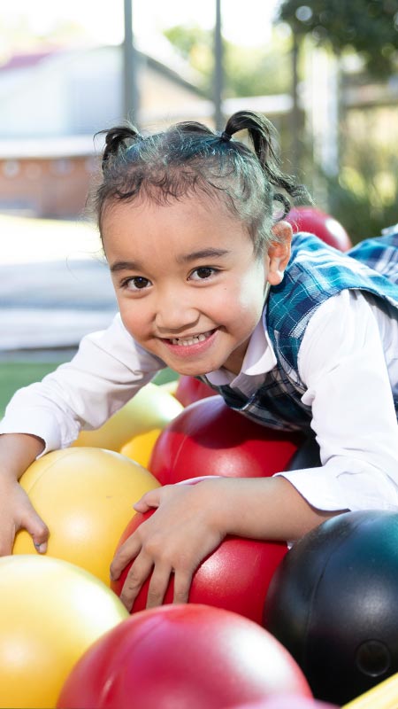 Holy Family Primary Emerton student on play equipment