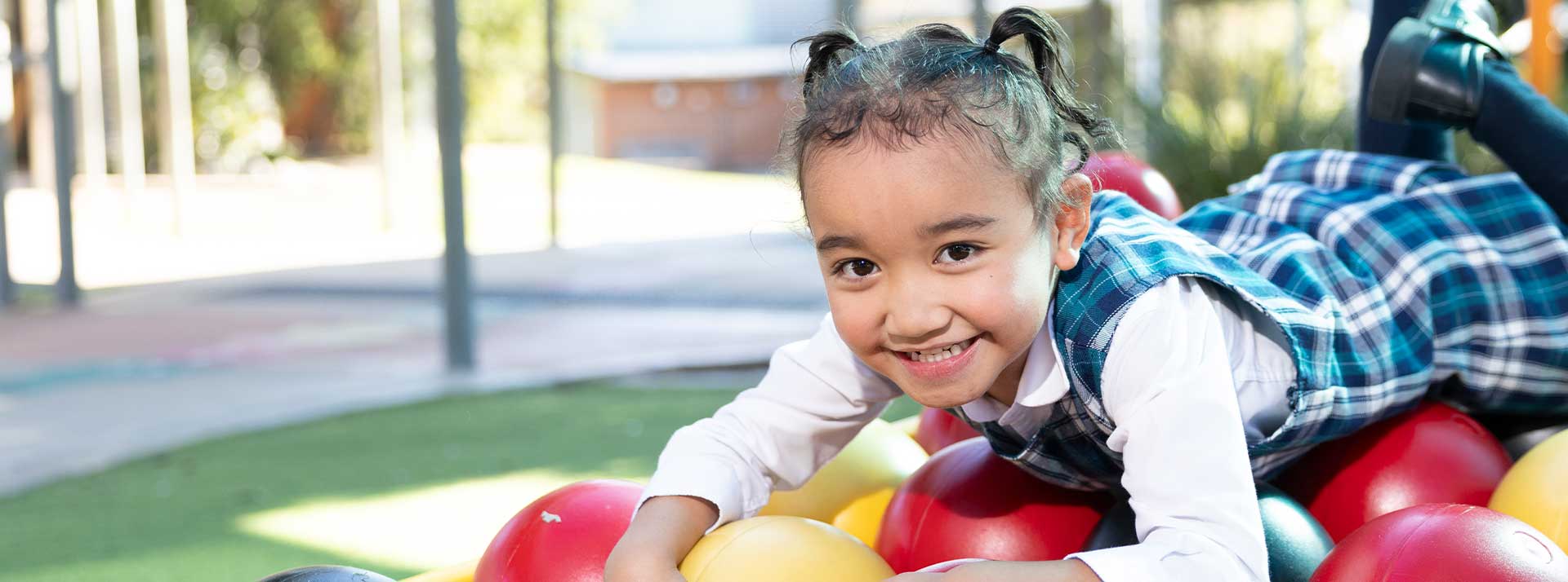 Holy Family Primary Emerton student on play equipment