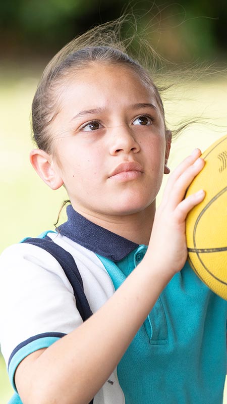 Holy Family Primary Emerton student shooting hoops