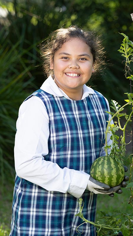 Girl gardening at Holy Family Primary Emerton