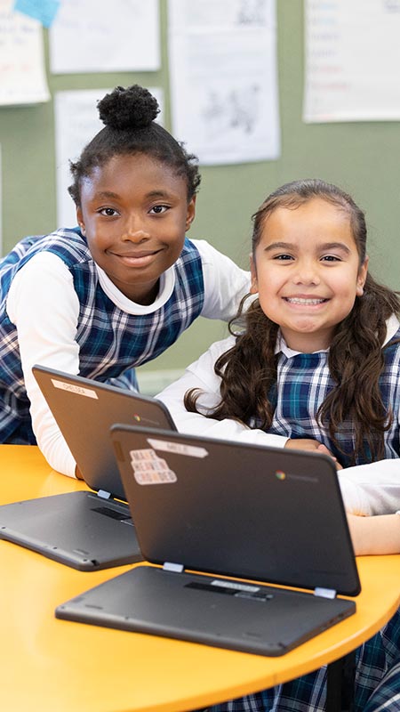 Holy Family Primary girls using Laptops in class