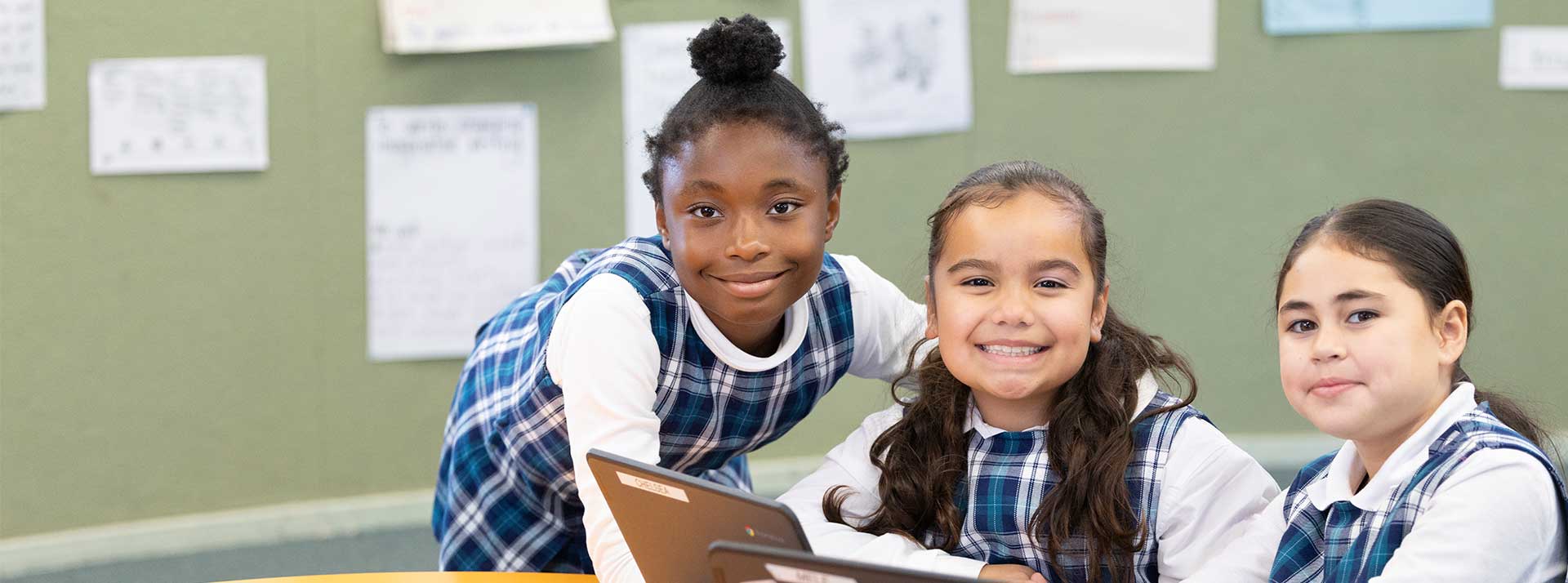 Holy Family Primary girls using Laptops in class