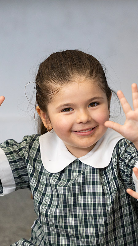 Holy Family Primary Emerton student counting on her fingers