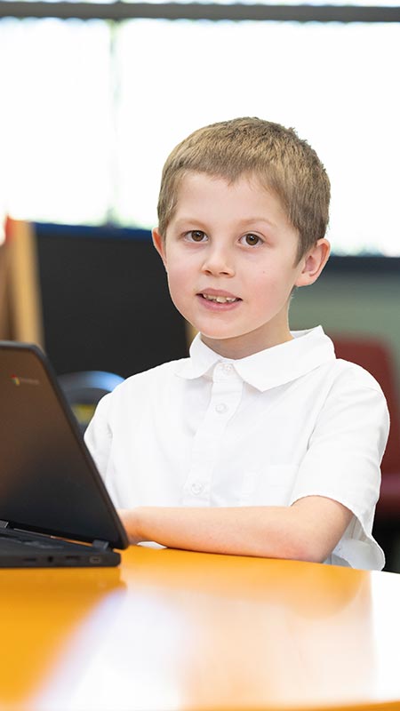 Holy Family Primary Emerton student on laptop
