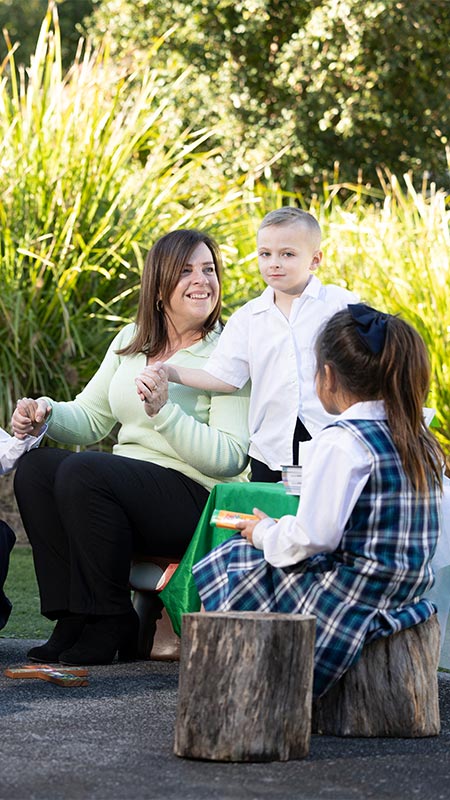 Holy Family Primary Emerton students and teacher in prayer circle