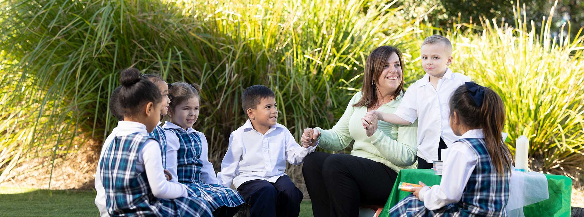 Holy Family Primary Emerton students and teacher in prayer circle