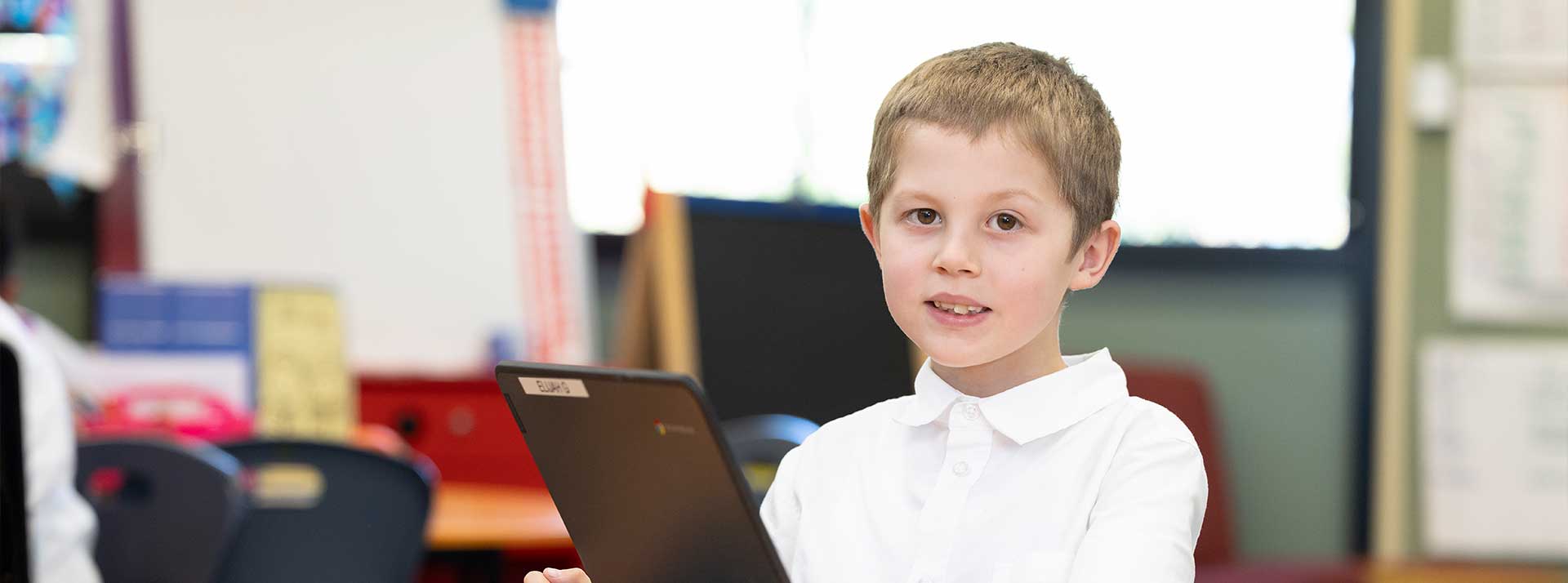 Holy Family Primary Emerton student on laptop