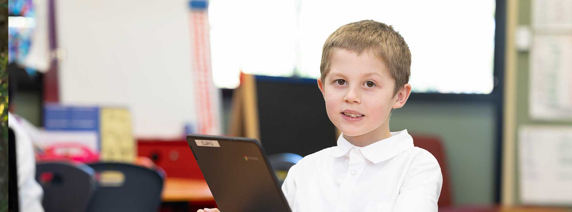 Holy Family Primary Emerton student in class using laptop