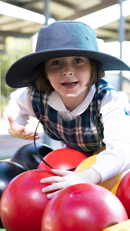 Holy Family Primary Emerton student on play equipment