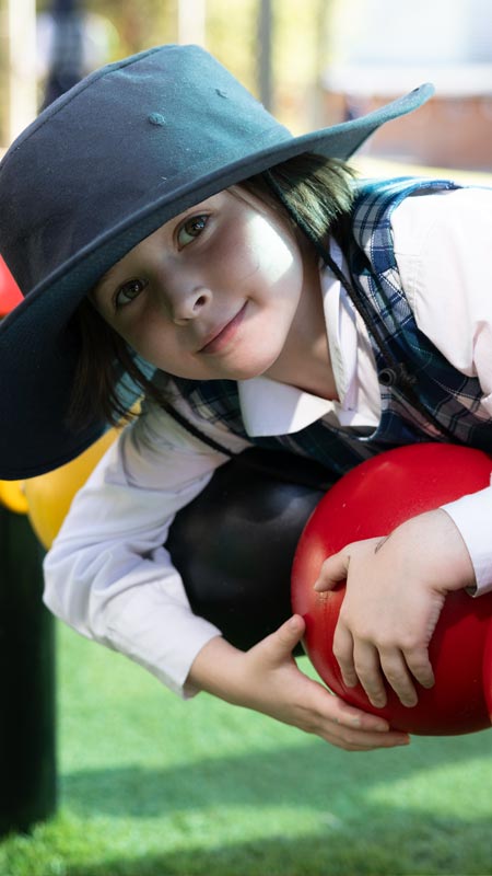 Holy Family Primary Emerton student on play equipment