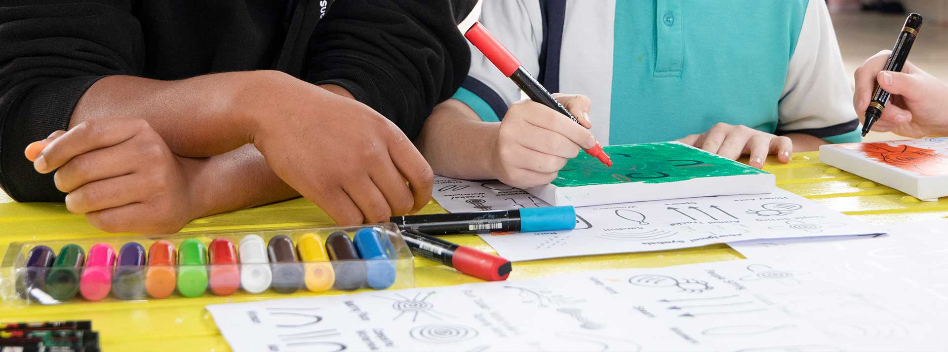 Students painting at Holy Family Primary Emerton