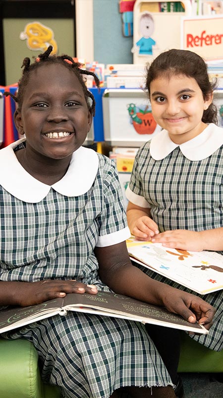 Two students in library at Holy Family Primary Emerton