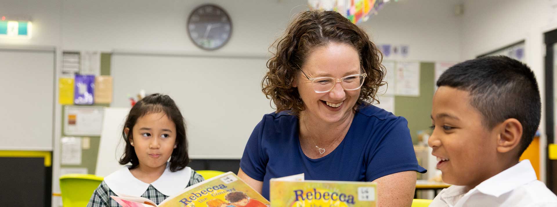 Margaret Rowan, Principal of Holy Family Emerton reading to happy students in class