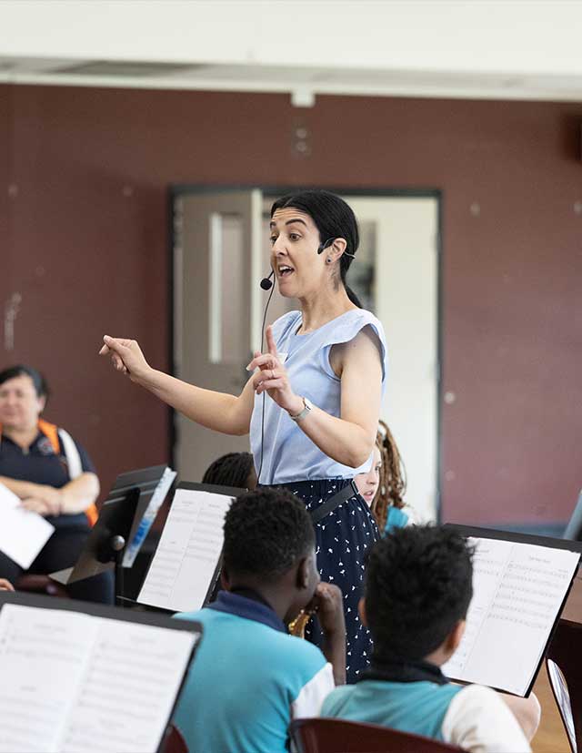 CSPD Music teacher conducting Holy Family Primary Emerton band students