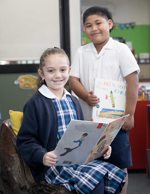 Two students in library at Holy Family Primary Emerton