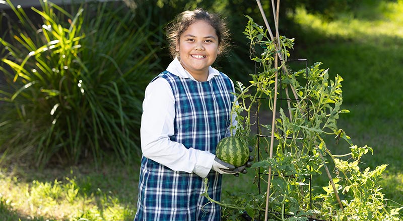 Holy Family Primary Emerton student gardening