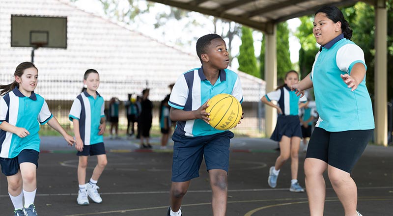 Holy Family Primary Emerton students playing basketball