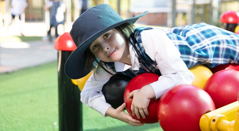 Holy Family Primary Emerton student on play equipment