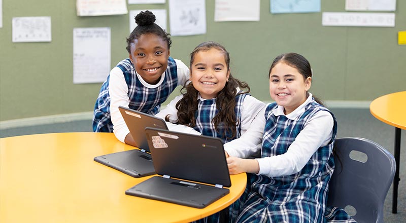 Holy Family Primary Emerton students using laptops