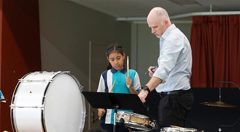 CSPD Music teacher assisting Holy Family Primary Emerton band student