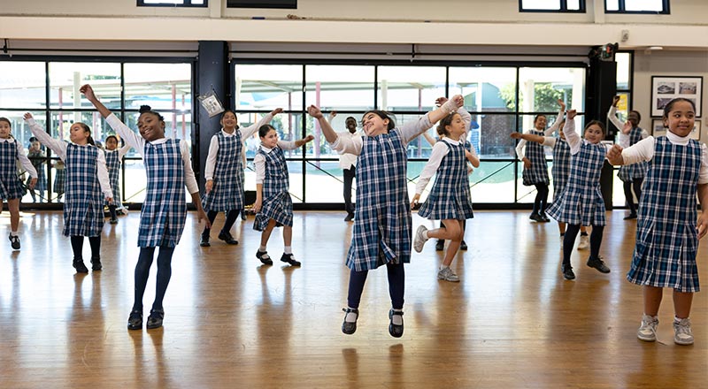 Holy Family Primary Emerton students dancing in school hall