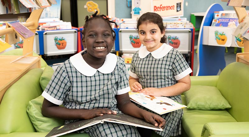 Two students in library at Holy Family Primary Emerton