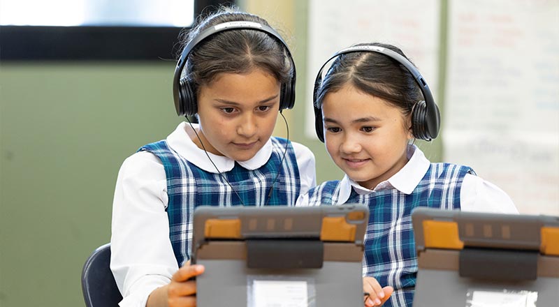 Two Holy family Primary Emerton students in class using iPads