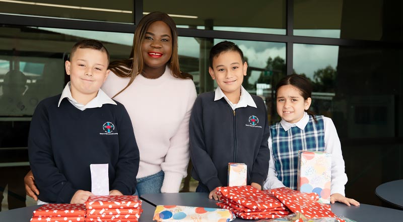 Parent and students assisting with social justice initiative at Holy Family Primary Emerton