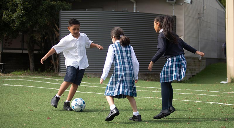 Holy Family Primary Emerton boy and girls playing soccer