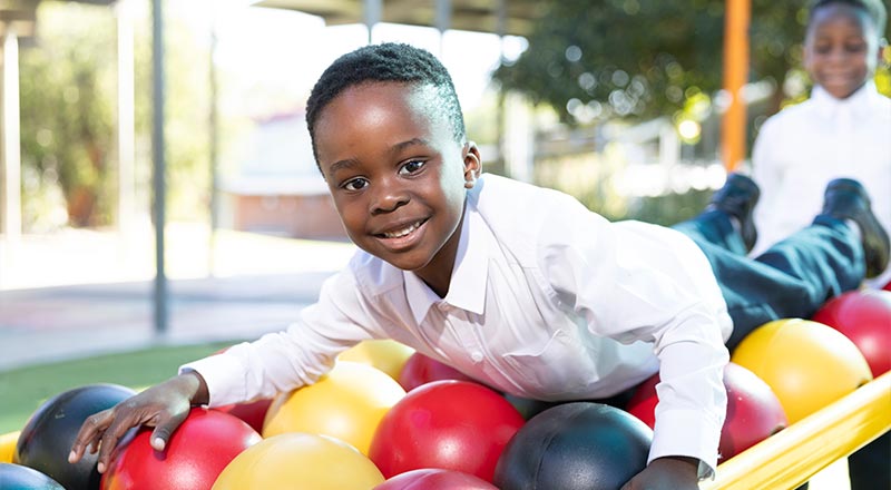 Holy Family Primary Emerton student on play equipment