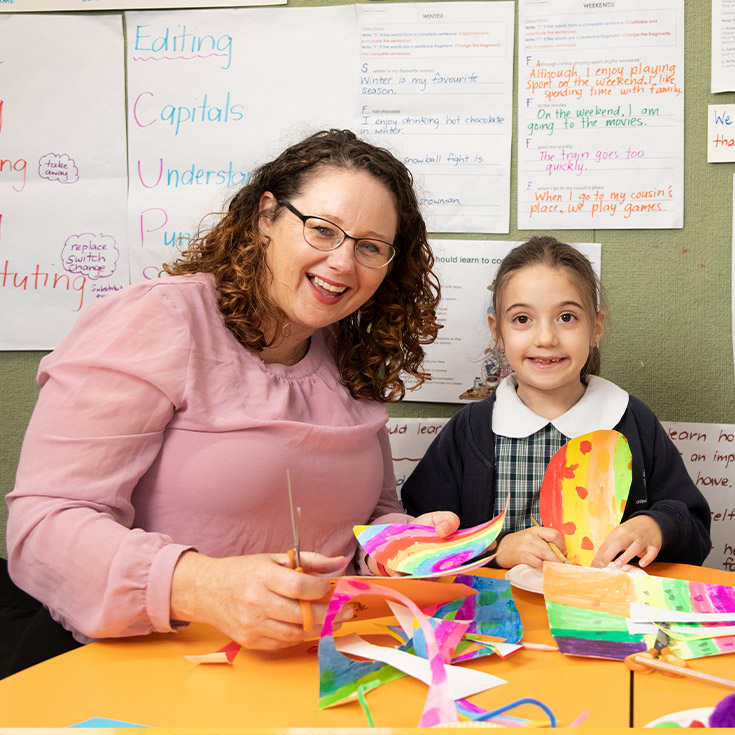 Margaret Rowan, Principal of Holy Family Emerton assisitng happy student in class